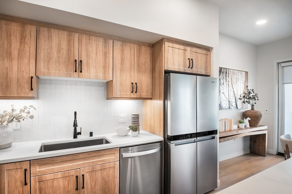 Kitchen with stainless steel appliances at Solana Winchester Hills Temecula apartments.
